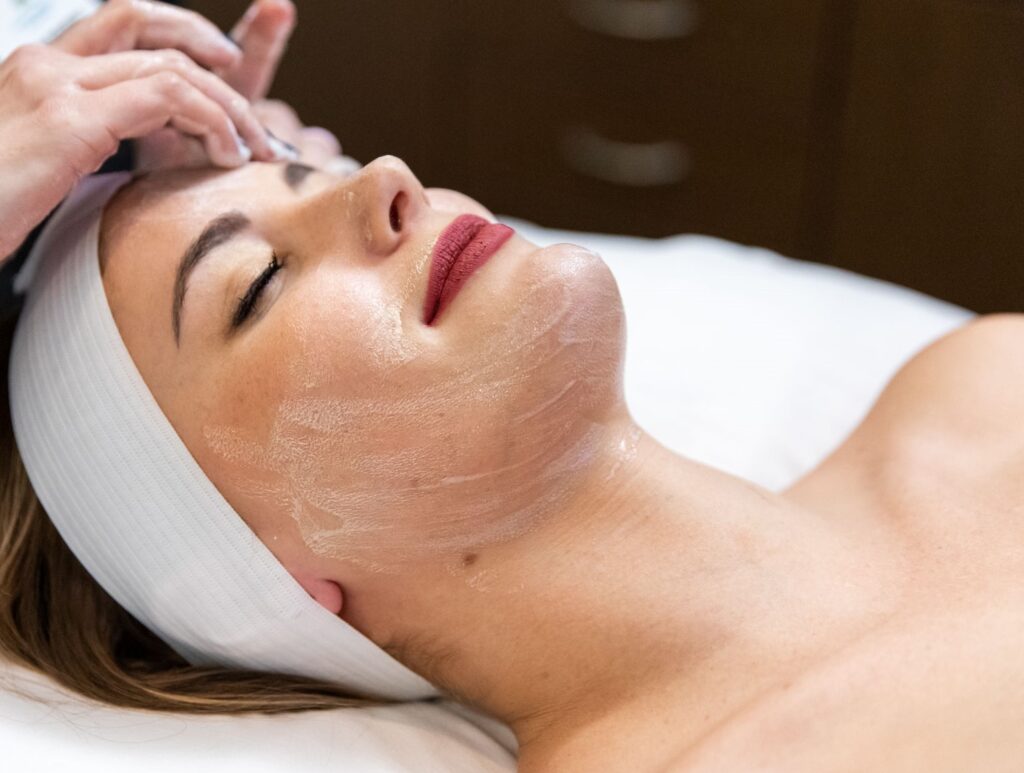 Woman laying down with eyes closed she receives facial contouring in OKC