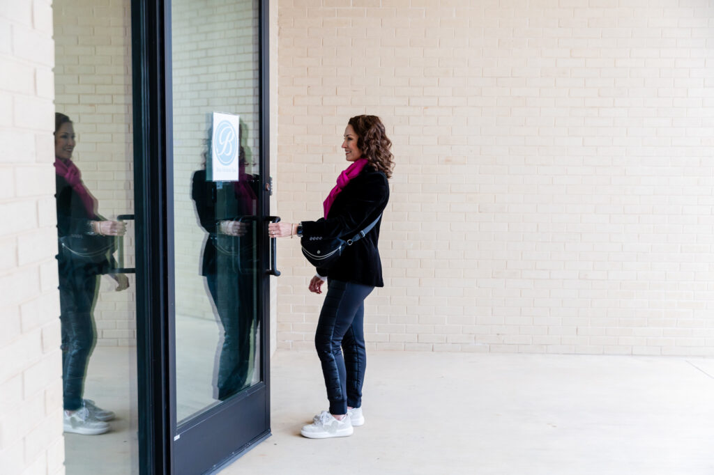 Woman stands outside of medspa in Wilshire to discuss Semaglutide weight loss near Edmond, OK, as part of a comprehensive weight loss program